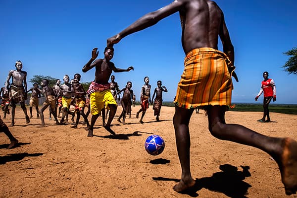 Image Name: Playing football of Kara Tribe Copyright: John Hantoro Pudjoko, 1st Place, Indonesia National Award, 2016 Sony World Photography Awards