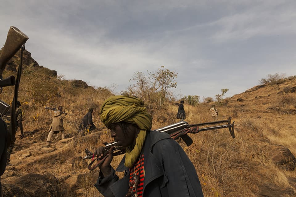 The Sudan Liberation Army led by Abdul Wahid (SLA-AW) climb towards the front lines in the last rebel-held territory in Central Darfur, Sudan, March 4, 2015.