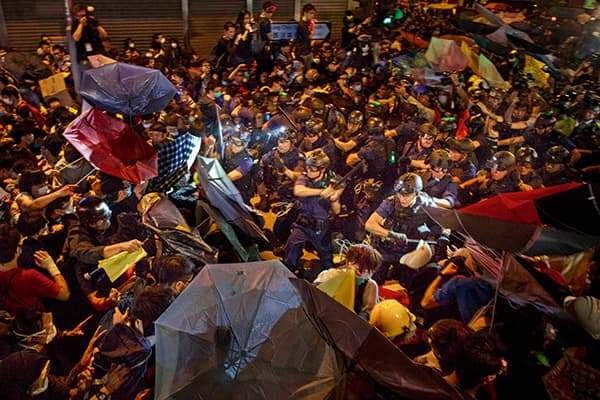 Protesters clash with police during a night of confrontation in the Mong Kok district of Hong Kong on 25 November 2014