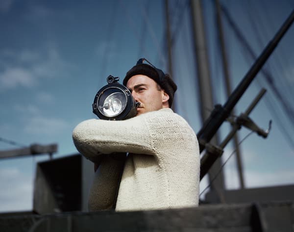 Robert Capa, [A crewman signals another ship of an Allied convoy across the Atlantic from the U.S. to England], 1942. © Robert Capa/International Center of Photography/Magnum Photos.