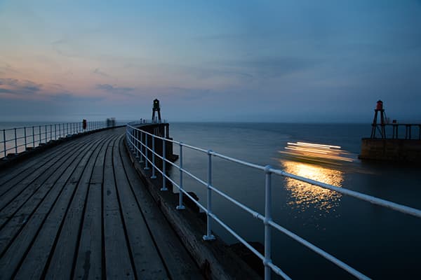 Streaks of light created by a boat leaving Whitby Pier made for a pleasing shot